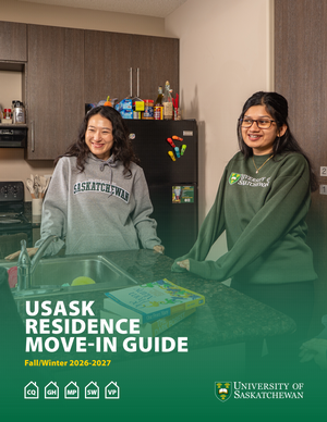 Two University of Saskatchewan students stand at a residence kitchen counter with a sink, cabinets, and refrigerator behind them; overlaid text reads “USask Residence Move-In Guide Fall/Winter 2026–2027.”